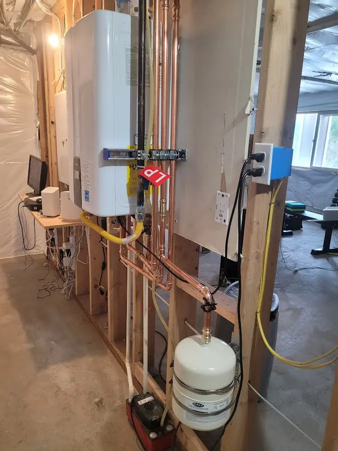 Licensed plumber repairing a kitchen sink in Ault